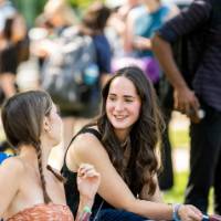 Students conversing in lawn chairs
